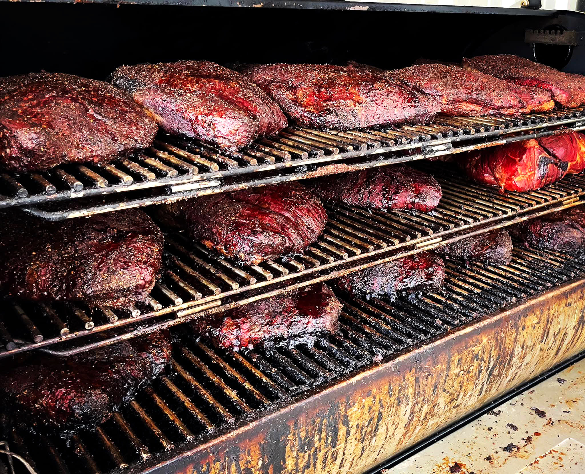 Rows of brisket in the smoker